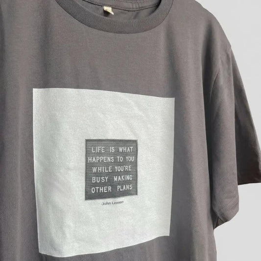 Gray t-shirt with a motivational quote on a white background