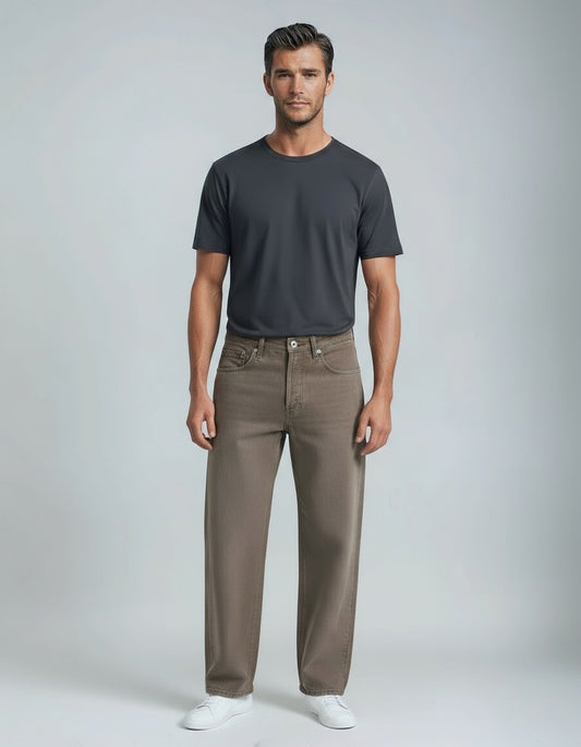 Man wearing a dark gray t-shirt and brown pants on a light gray background
