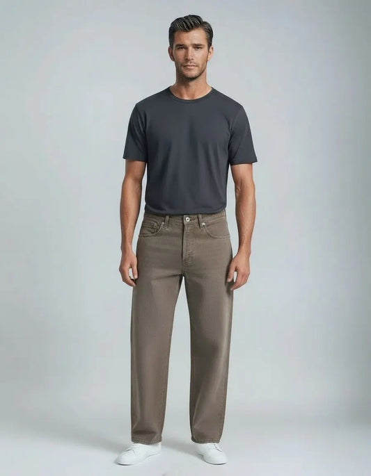 Man wearing a dark gray t-shirt and brown pants on a light gray background