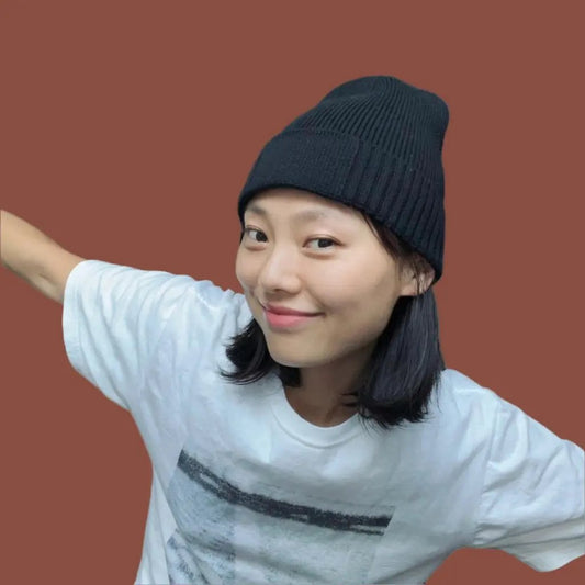 Person wearing a black beanie and white t-shirt
