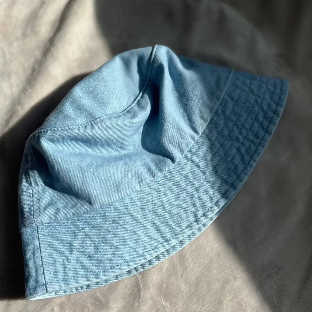 washed blue bucket hat flat lay product photo