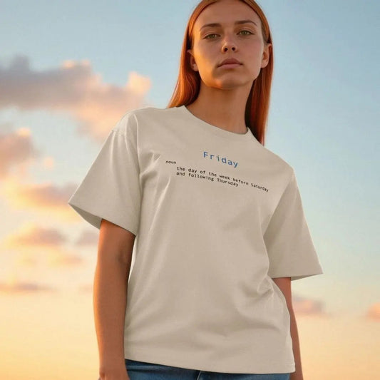 Person wearing a beige t-shirt with text against a sunset sky