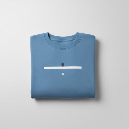 Folded blue sweatshirt with a minimalistic design on a light gray background