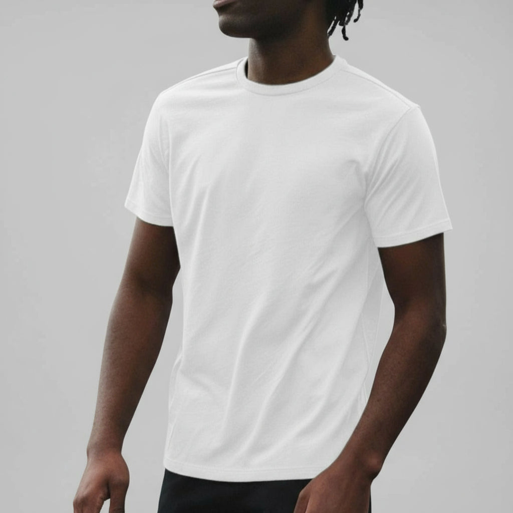 Person wearing a plain white t-shirt against a gray background