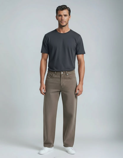 Man wearing a dark gray t-shirt and brown pants on a light gray background