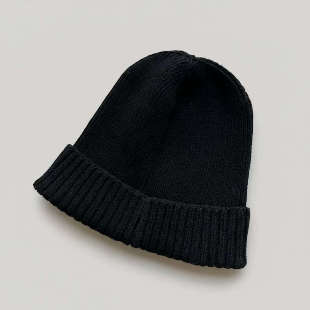 Black knit beanie on a light gray background