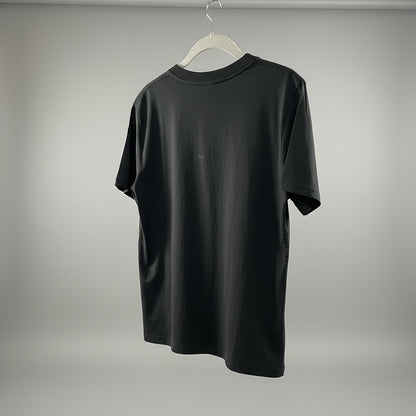 Black t-shirt on a hanger against a gray background