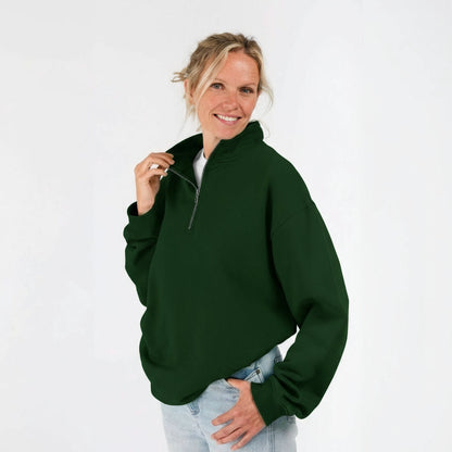 Woman wearing a green quarter zip