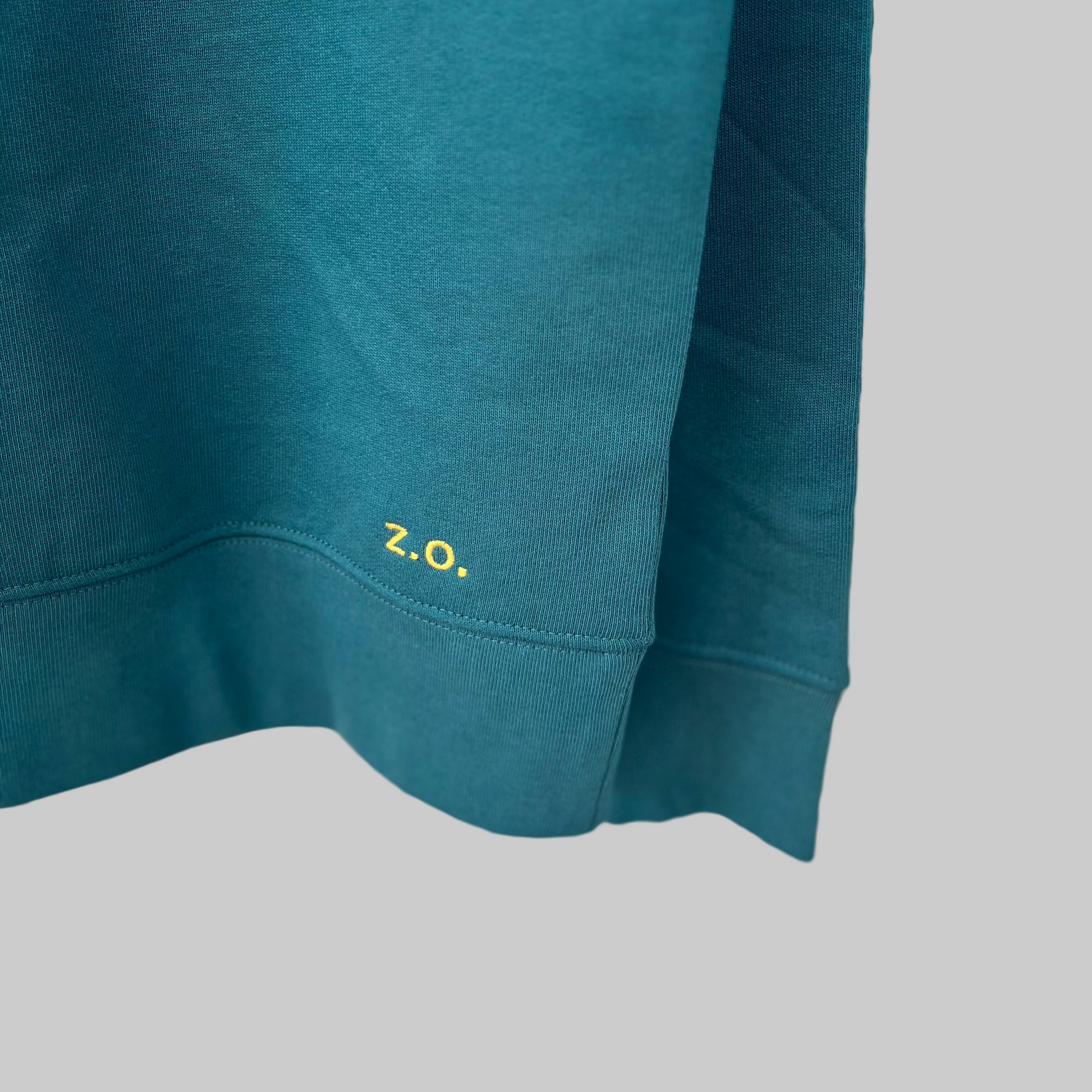 Teal sweatshirt with a small 'Z.O.' logo