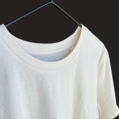 White t-shirt on a hanger with a blurred background