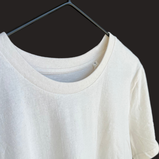 White t-shirt on a hanger with a blurred background