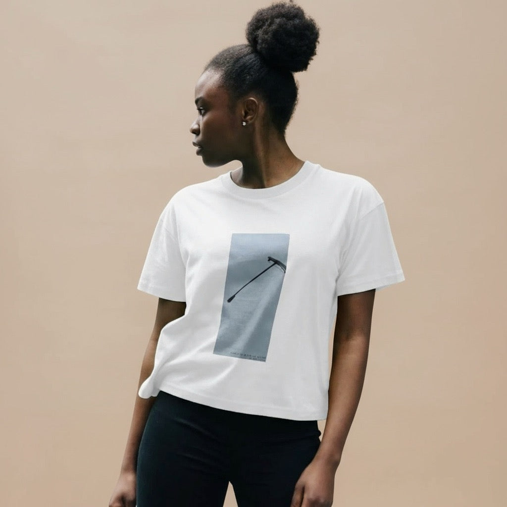 Woman wearing a white t-shirt with a graphic design on a beige background