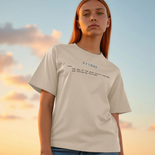 Person wearing a beige t-shirt with text that says friday and its dictionary definition printed on the chest