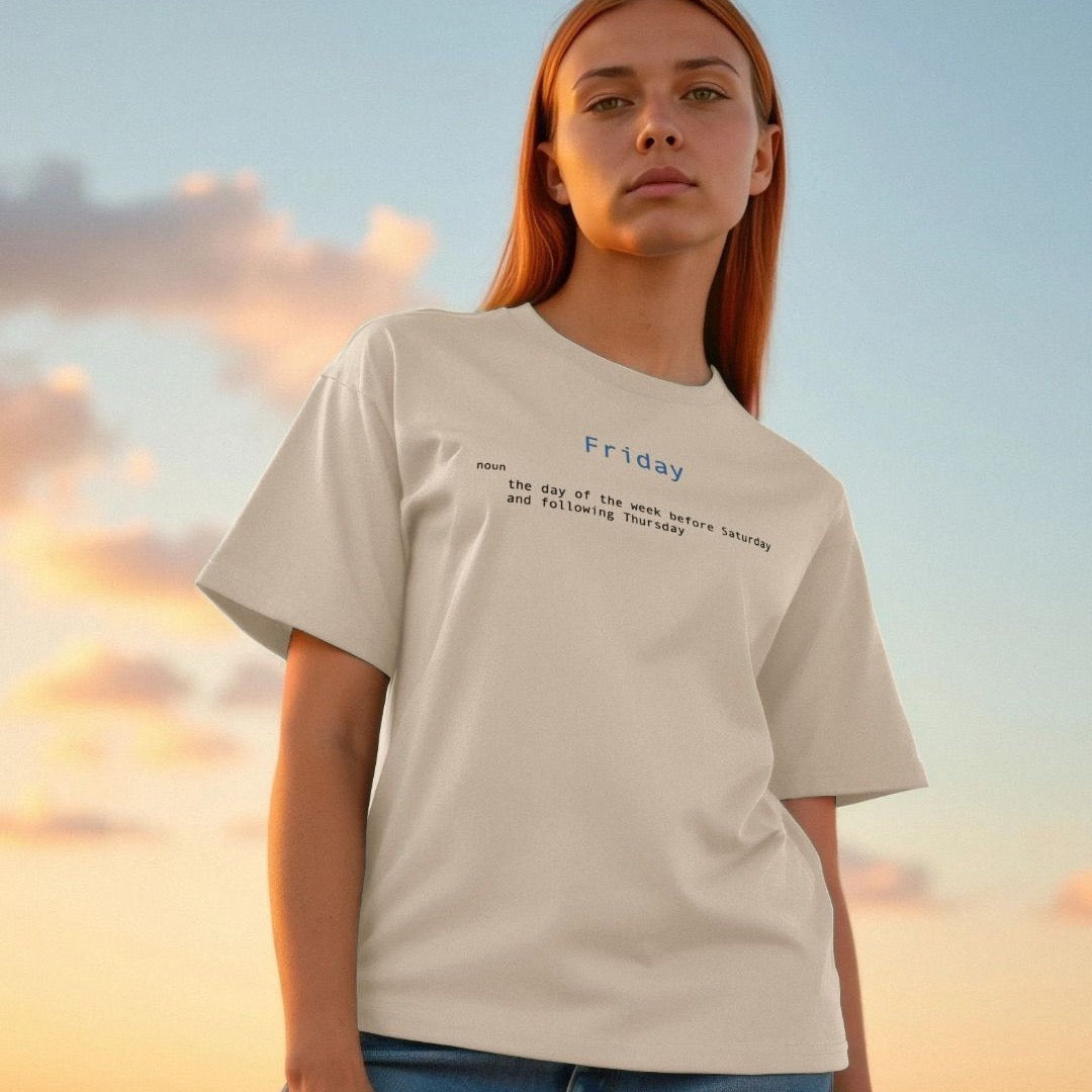 Person wearing a beige t-shirt with text against a sunset sky