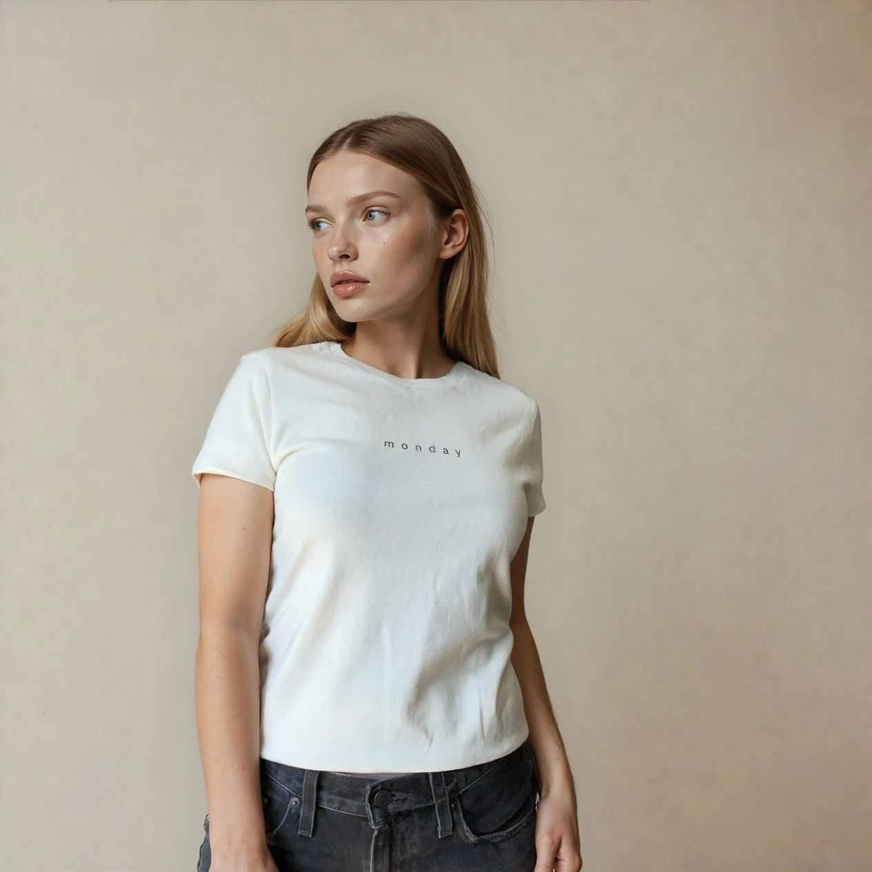 Woman wearing a white t-shirt with 'Monday' text printed on the chest