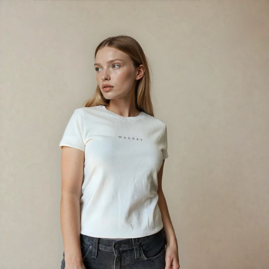 Woman wearing a white t-shirt with 'Monday' text printed on the chest